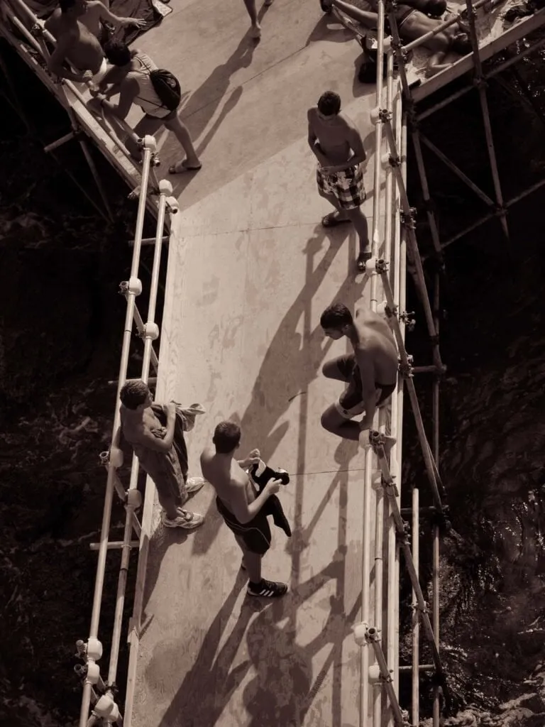 pair Sightseers on a scaffolded stair, shot from above