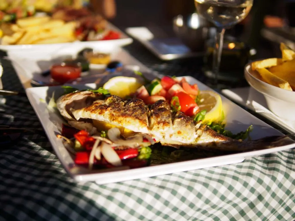 pair Grilled sea bass on a green-check tablecloth at the Vineyard Taverna