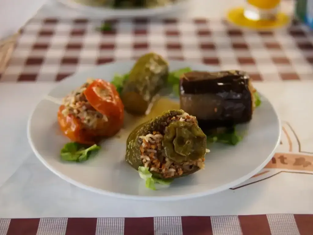 pair Gemista — stuffed tomato, pepper and aubergine — on a gingham tablecloth at Laona